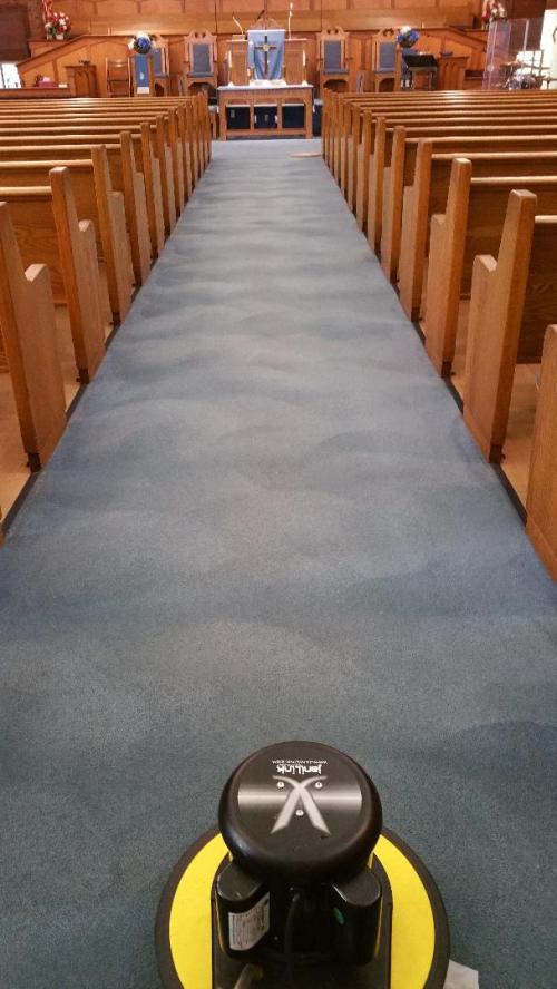 Church aisle carpet being cleaned